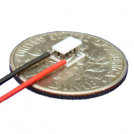 image of mini micro peltier TEC cooler module 00411-9J30-20CN shown sitting on USA Dime 10 cent coin for scale