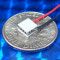 image of mini micro peltier TEC cooler module 00711-5A30-12CU4 shown sitting on USA Dime 10 cent coin for scale